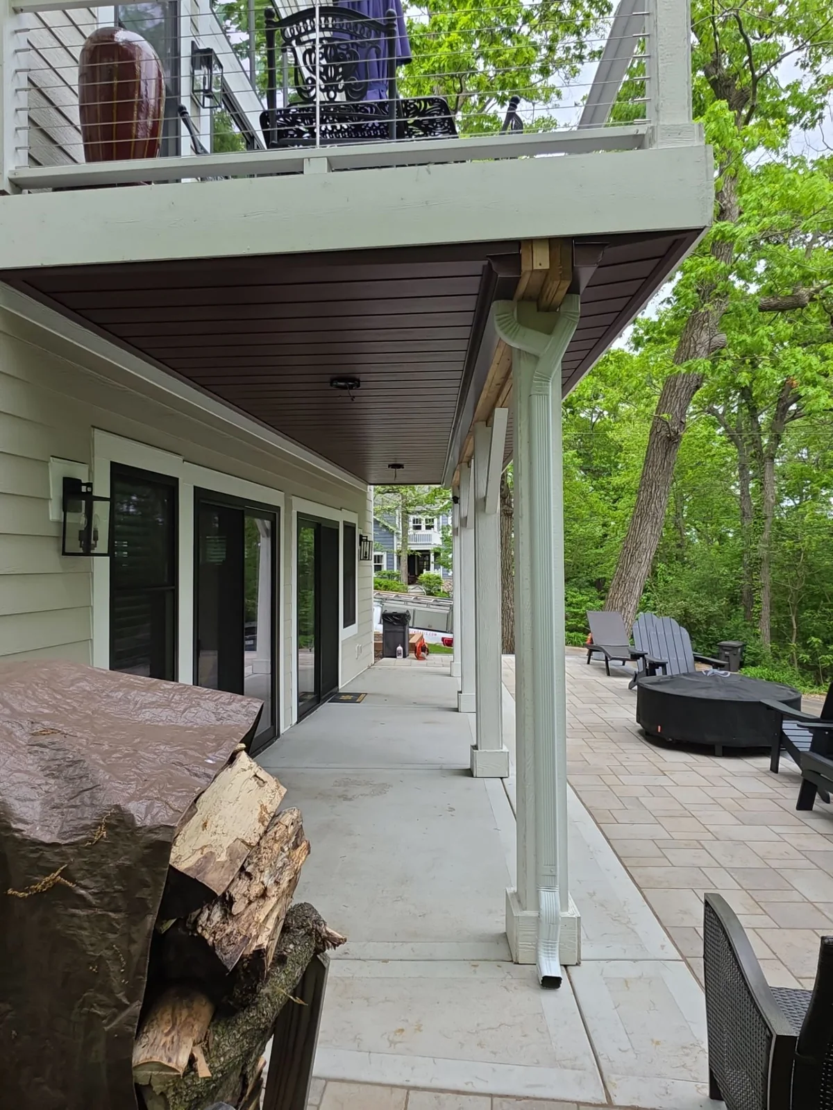 Finished under-deck ceiling protecting an outdoor living area