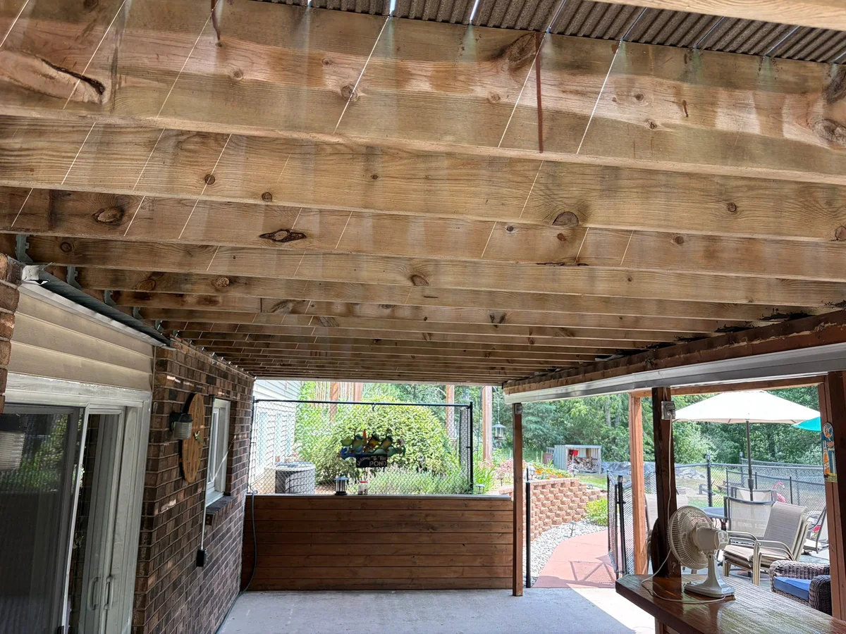 Exposed deck joists above an Under Deck Oasis installation