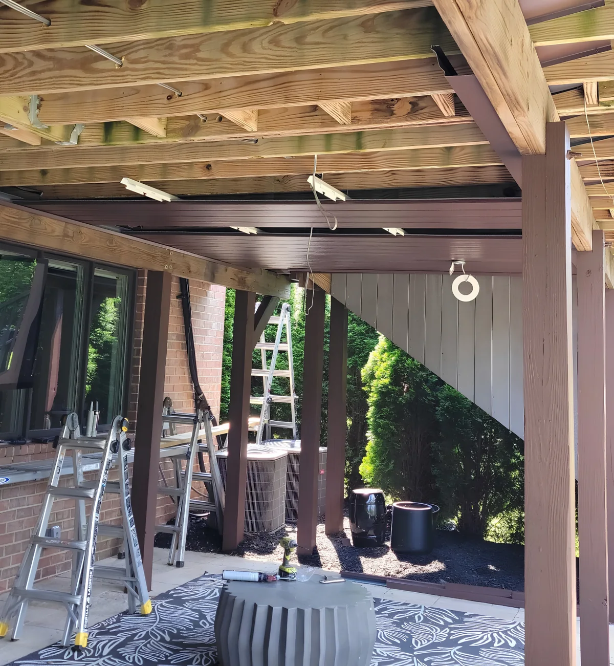 Under Deck Oasis ceiling panels partially installed beneath deck framing