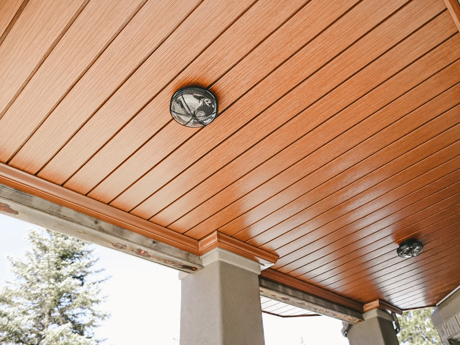 Warm woodgrain Under Deck Oasis ceiling panels with surface-mounted lighting