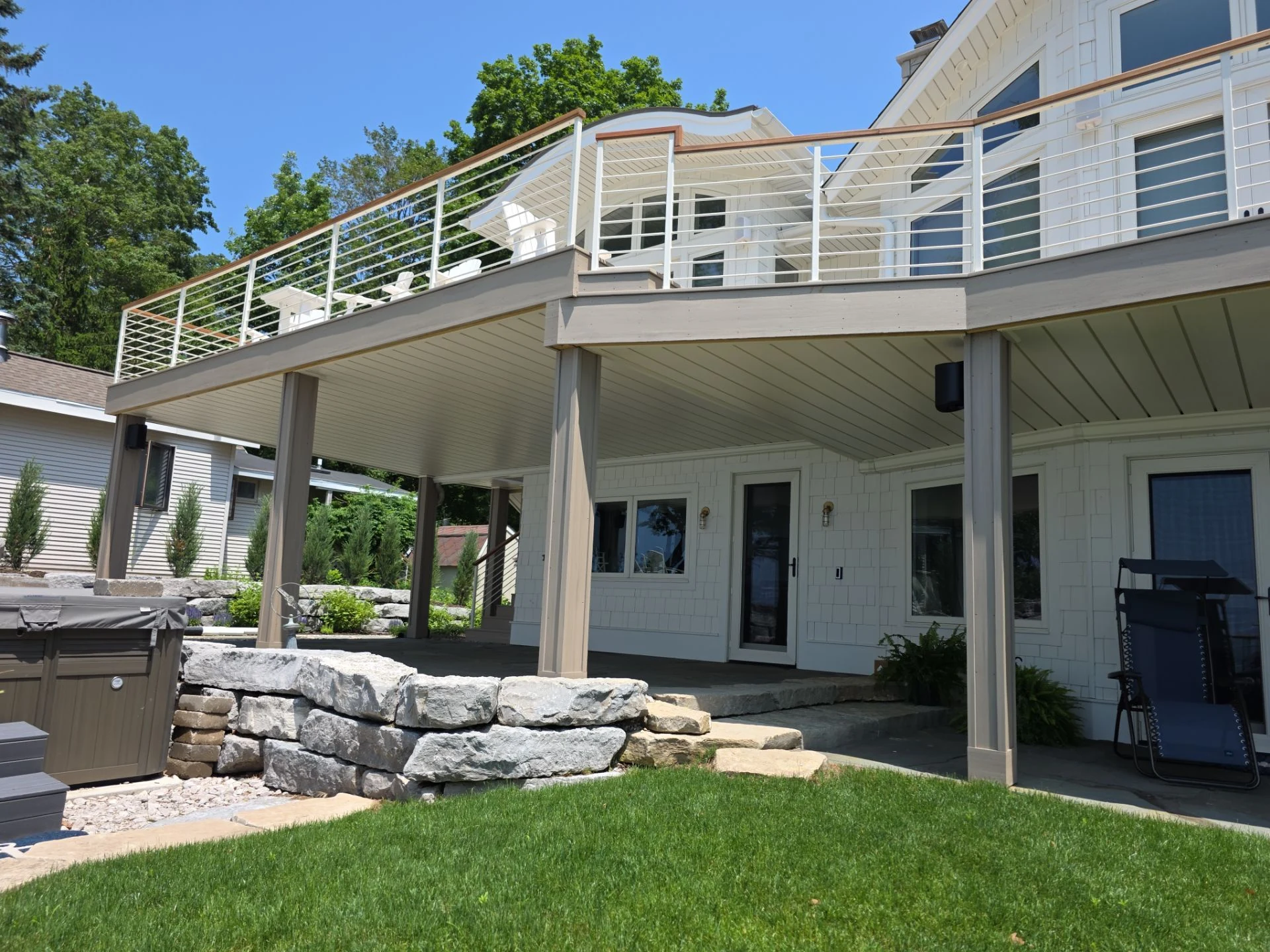 Finished interlocking aluminum ceiling panels beneath a deck
