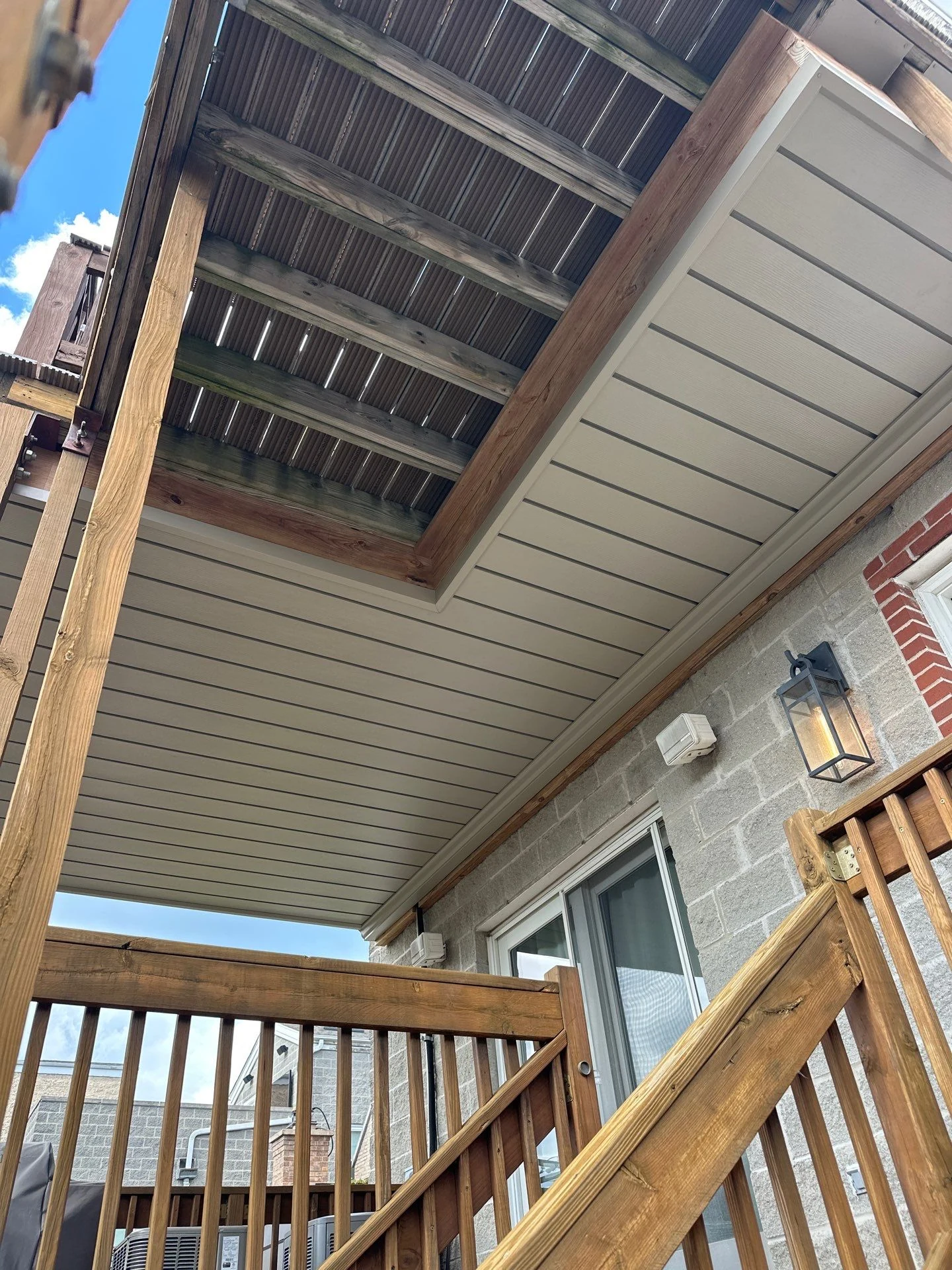 Rustic Clay ceiling installed around existing beams beneath a Chicago deck