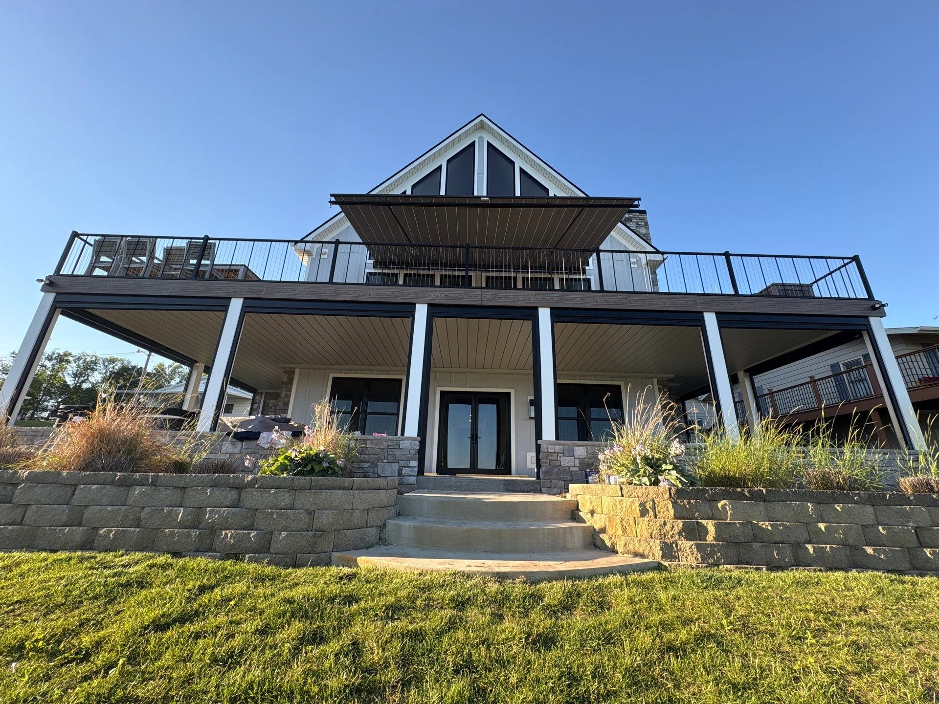 Lakefront home with a finished Rustic Pewter ceiling beneath a large deck