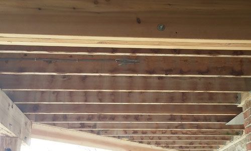 Electrical lead location marked between deck joists